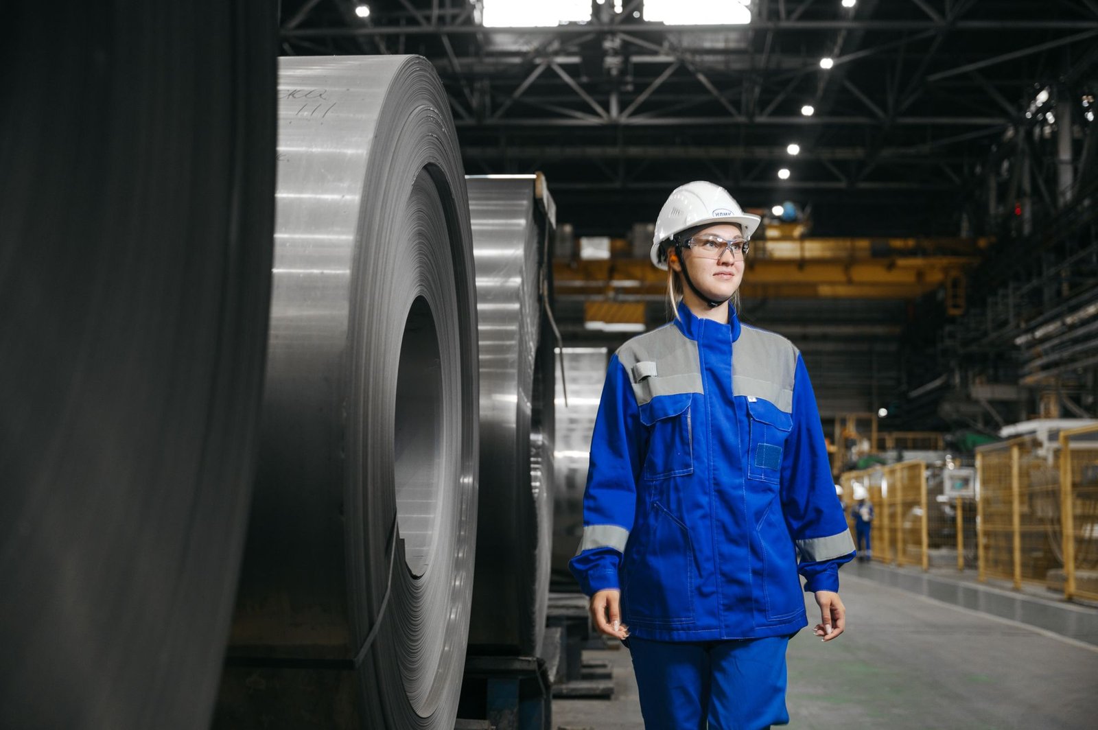 Steel industry specialist beside a steel coil